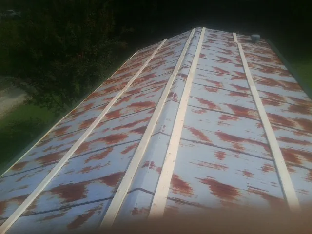 Rusted metal roof panels with new wood purlins before replacement — Storm Damage Roof Repair in Raphine by Roofing Brothers