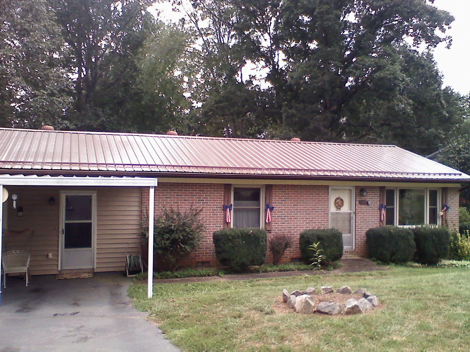 Bronze metal roof and carport on a brick ranch home — Roof Repair work by our crew in Raphine